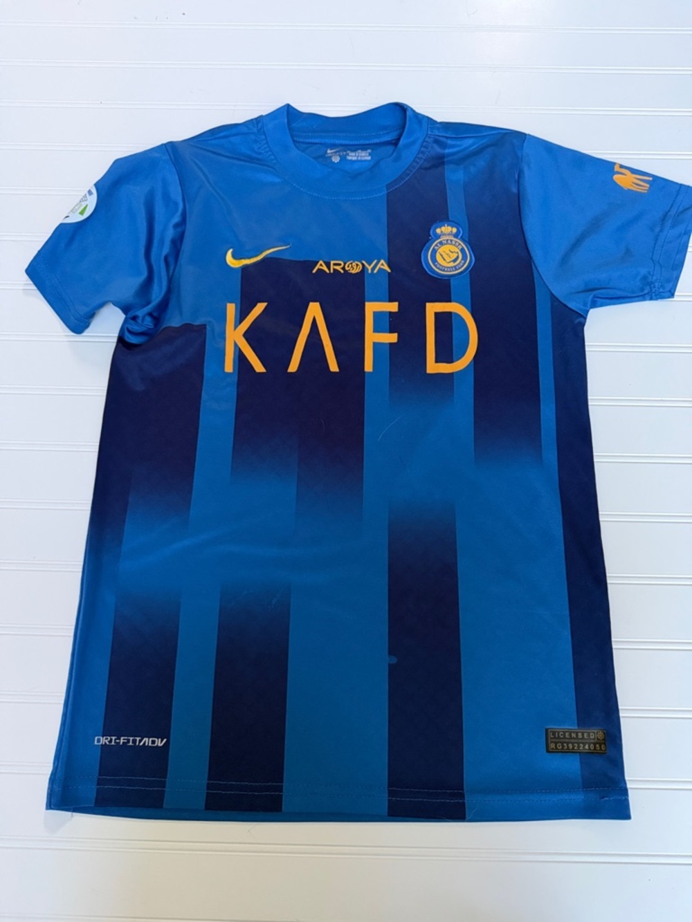 (121)Nike Boys Blue Striped Soccer Jersey with Gold Logos